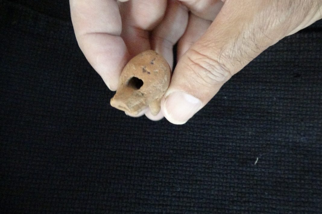 A 2,000-year-old whistle made of terracotta from the Roman period was found in a child's grave as a grave gift, Çanakkale, Türkiye, Oct. 18, 2022. (IHA Photo)