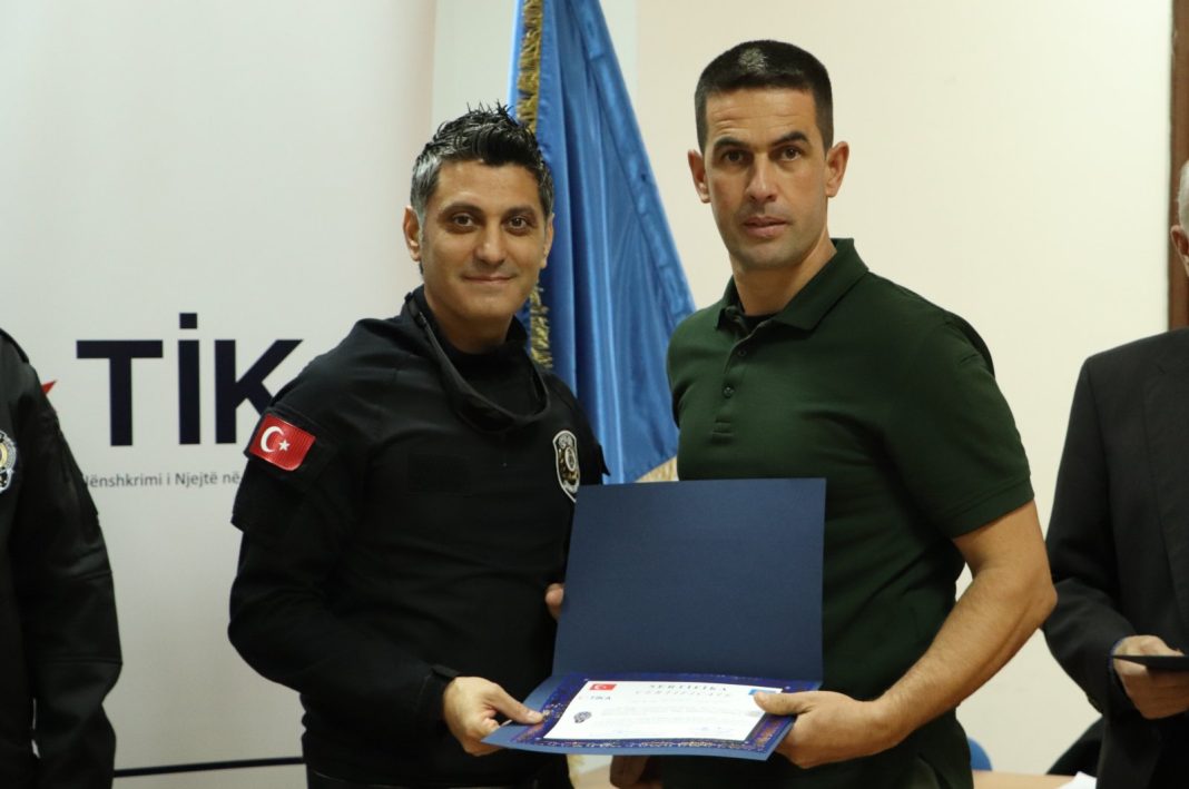 A Kosovar police officer (R) receives certification after the training program, Pristina, Kosovo, Oct. 18, 2022. (AA Photo)