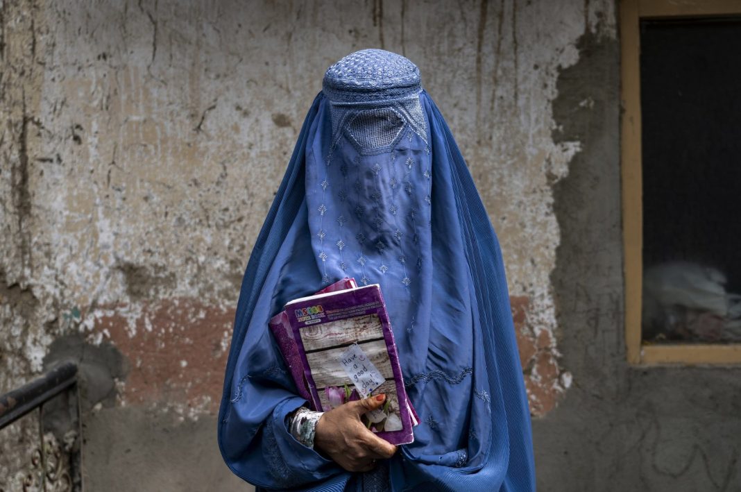 Forty-year-old Arefeh leaves an underground schoolin Kabul, Afghanistan, July 30, 2022. (AP Photo)