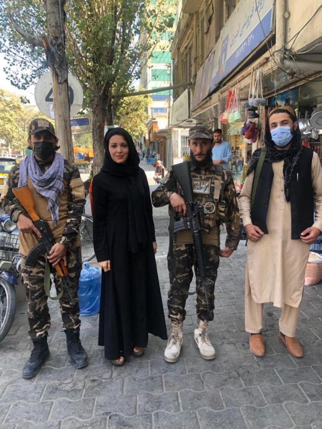 Turkish journalist Nagehan Alçı poses with local people, Kabul, Afghanistan, Oct. 2022. (Photo by Nagehan Alçı)