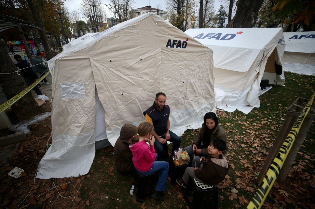 A family having breakfast outside their tent, in Düzce, northern Türkiye, Nov. 24, 2022. (AA Photo)
