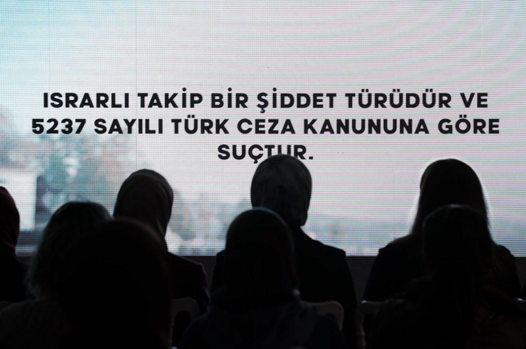 An audience watches a short video by the Women and Democracy Association (KADEM) as the point 