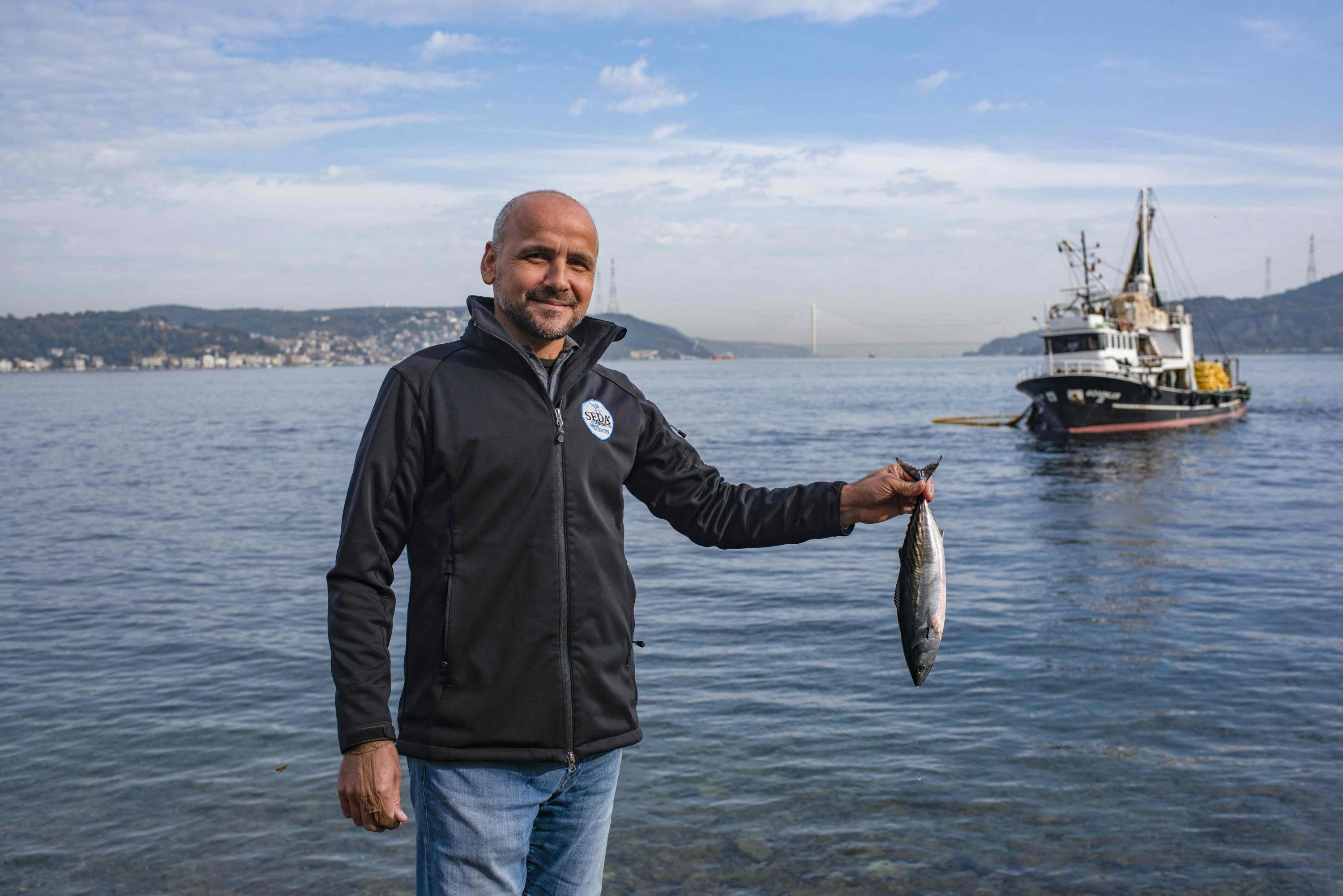 Mehmet Doğan, an amateur fisherman, poses for a photograph on the bank of the Bosporus, in Istanbul, Türkiye, Nov. 6, 2022. (AFP Photo)