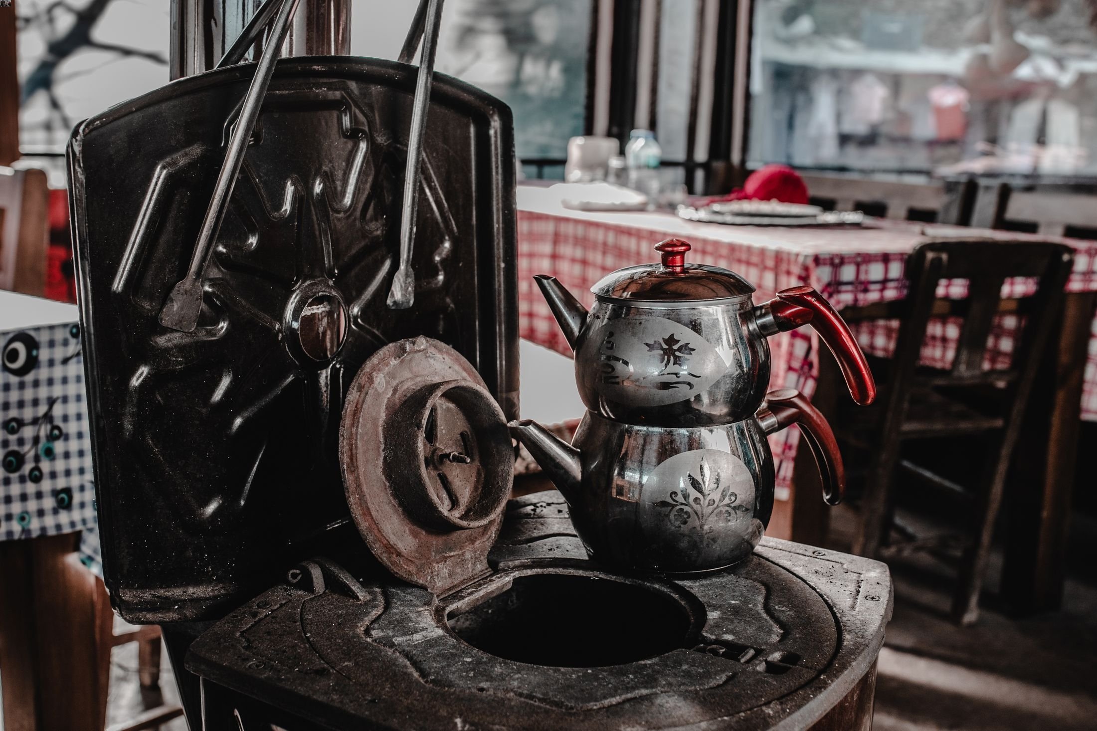 Turkish tea maker on a traditional soba, or coal-burning stove, in Şirince, Izmir, Türkiye. (Shutterstock Photo)