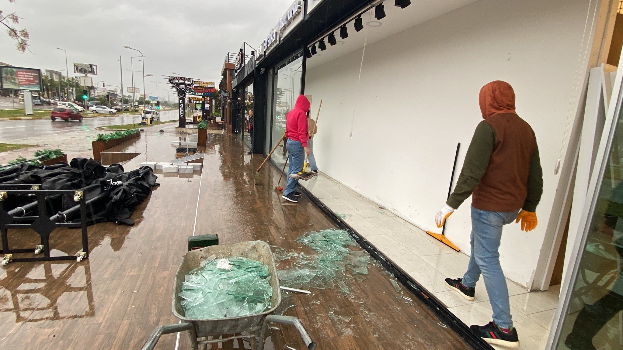 251350 Shop window glass is seen scattered after the rainfall in Antalya, Türkiye, Jan. 12, 2023. (IHA Photo)
